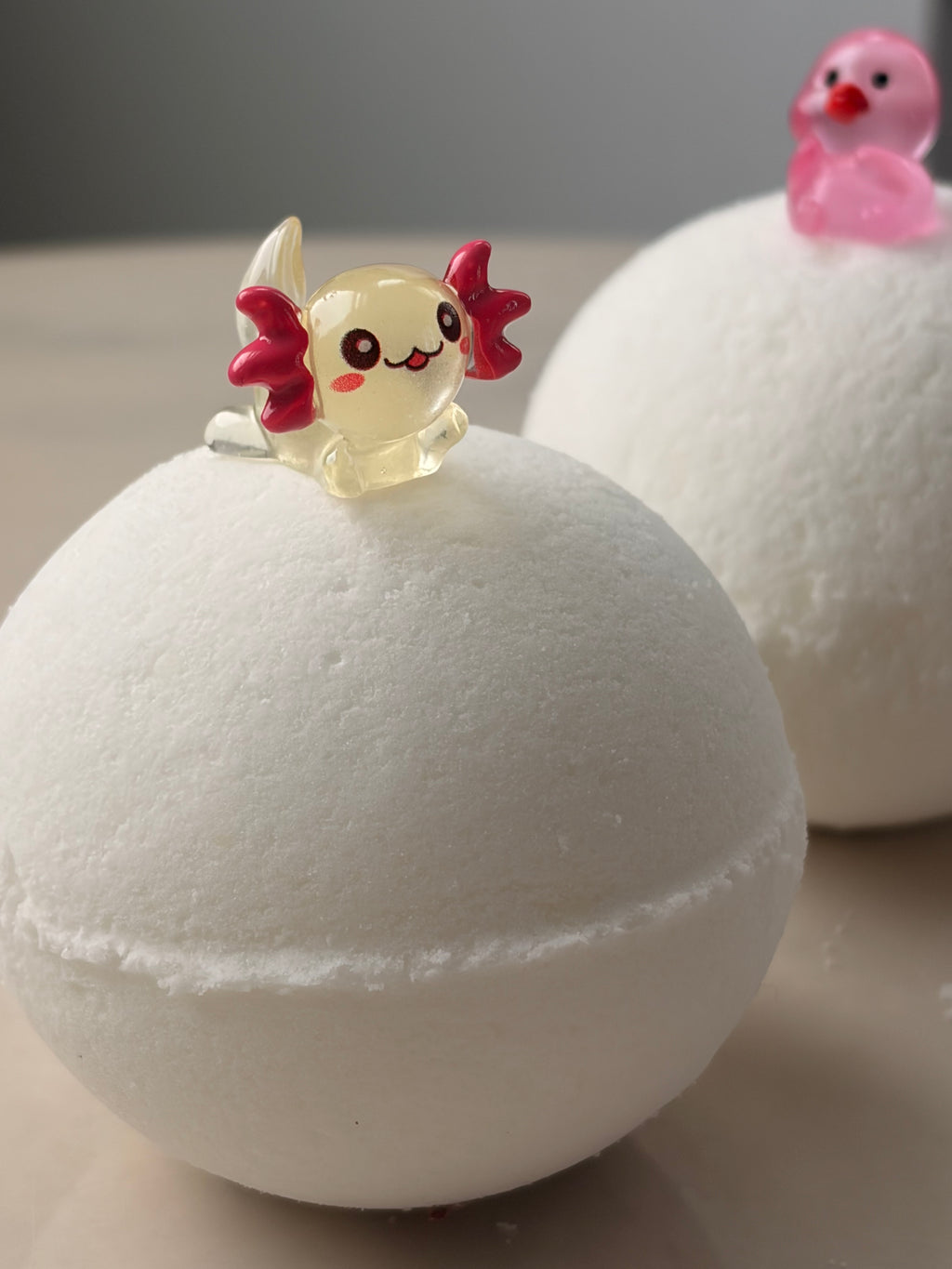 Unscented, eczema-friendly bath bomb for sensitive skin, handpressed 4.1 oz sphere with a hidden axolotl  and duck toy surprise